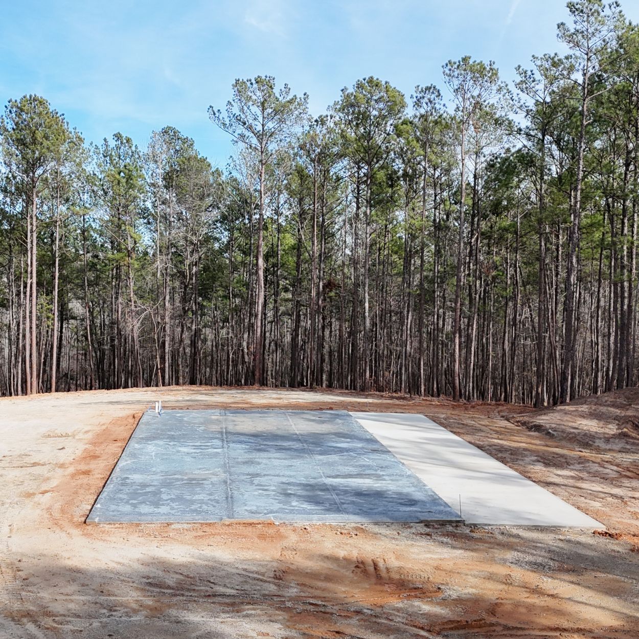 A concrete foundation is being built on a construction site.