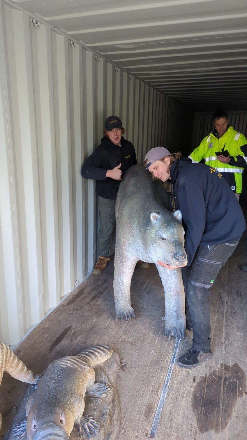 A Group of Men Are Moving a Polar Bear Statue Into a Shipping Container — Leader Removals & Storage in Gunning, NSW