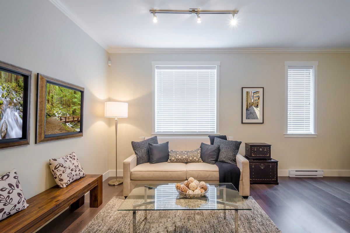 A Living Room with A Couch, Coffee Table, and Television — Leader Removals & Storage in Mitchell, ACT