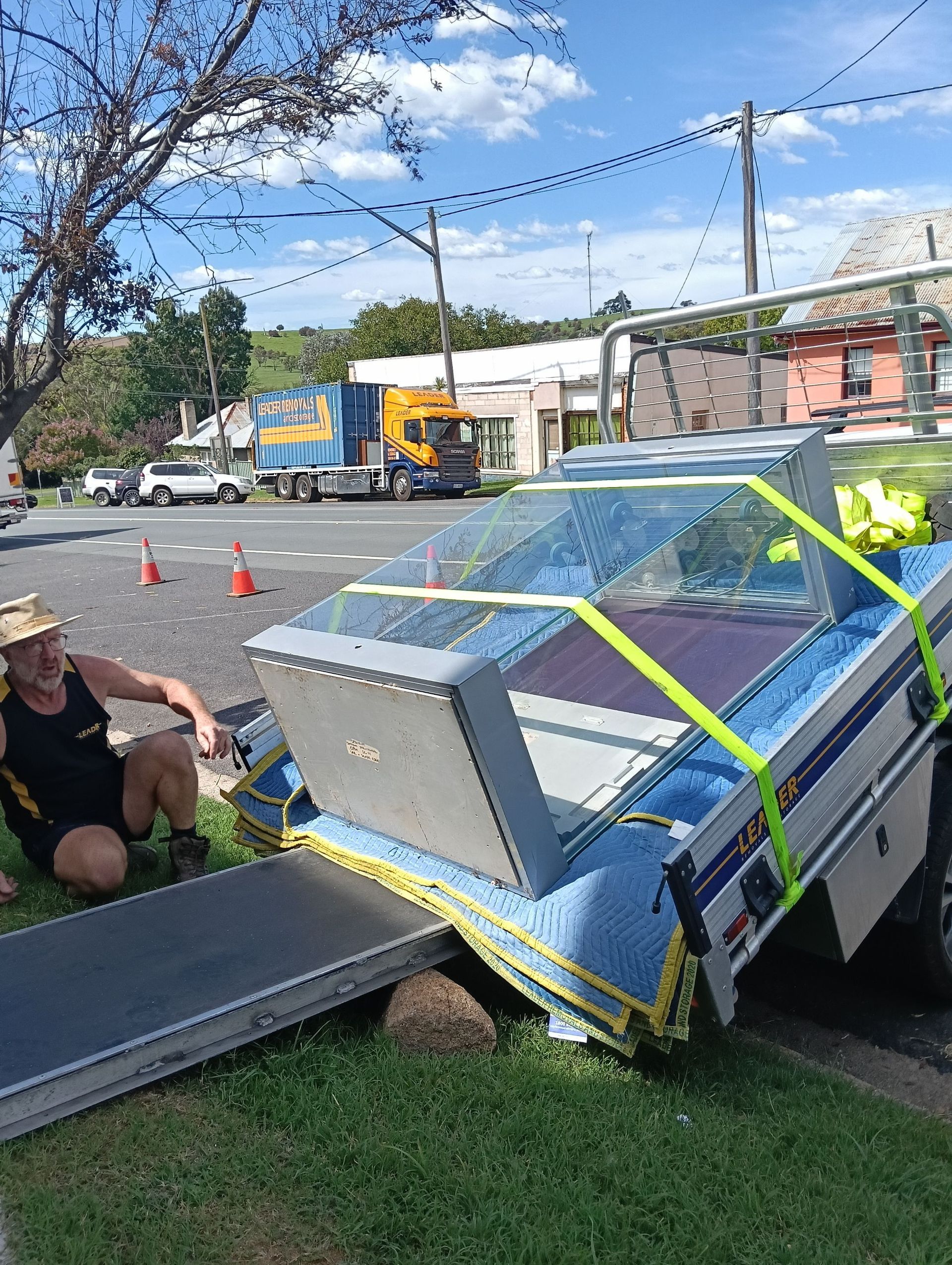 A Man Next to Car Moving a Large Cabinet — Leader Removals & Storage in Mitchell, ACT
