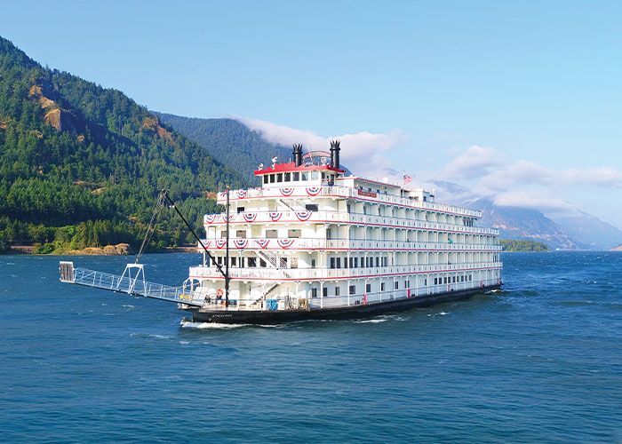 paddle wheel river boat with mountains and bluewater