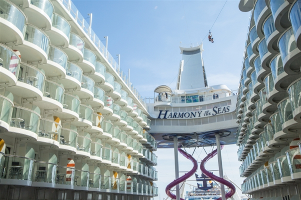 A cruise ship with a slide between two buildings.