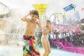 A boy and a girl are playing in a water park.