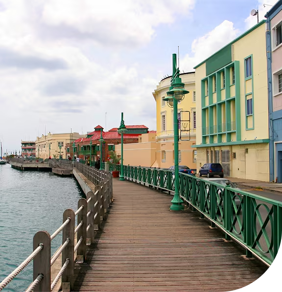 long boad walk lined by green railing an old town