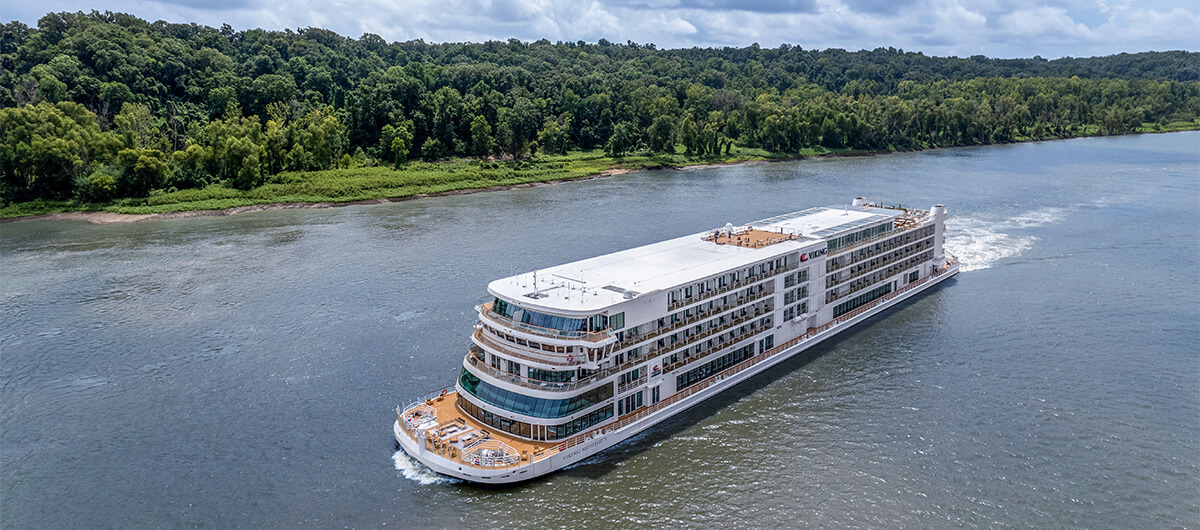 a large VIKING cruise ship is floating on top of a large body of water .