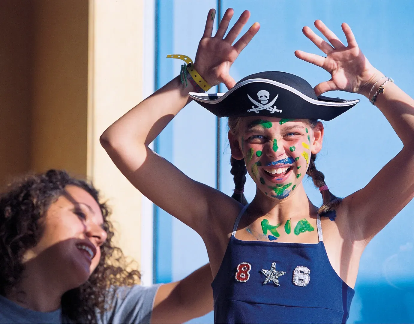 yung girl dressed as pirate with face paint and parent assisting