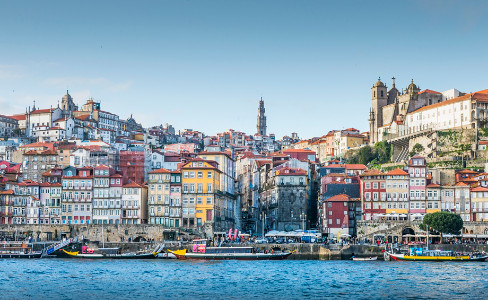 colorful town, churh steeples, river boats, water