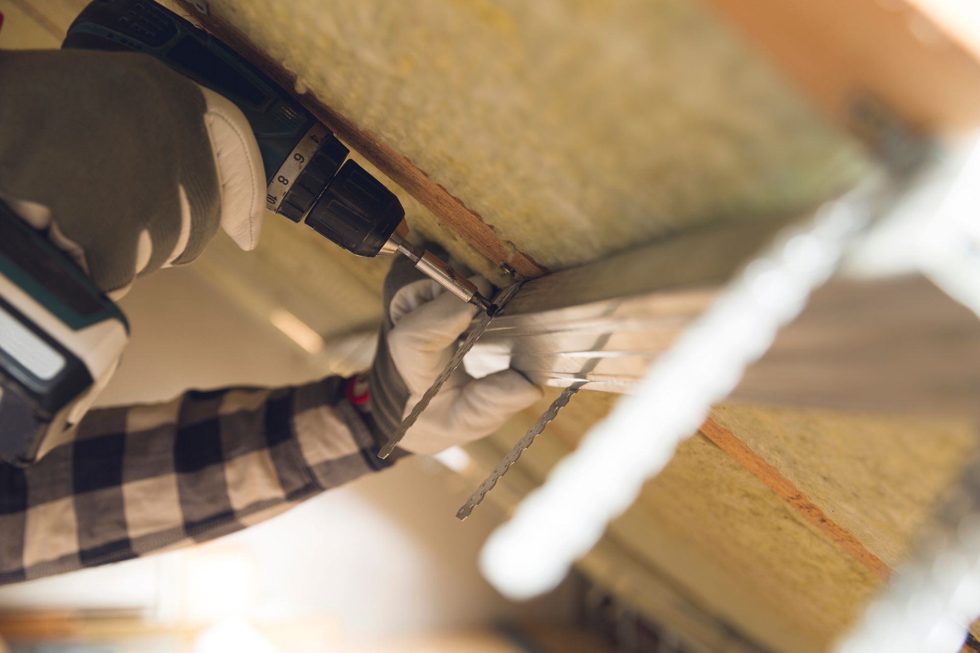 Man installing mineral wool panels, showcasing expert new construction insulation.