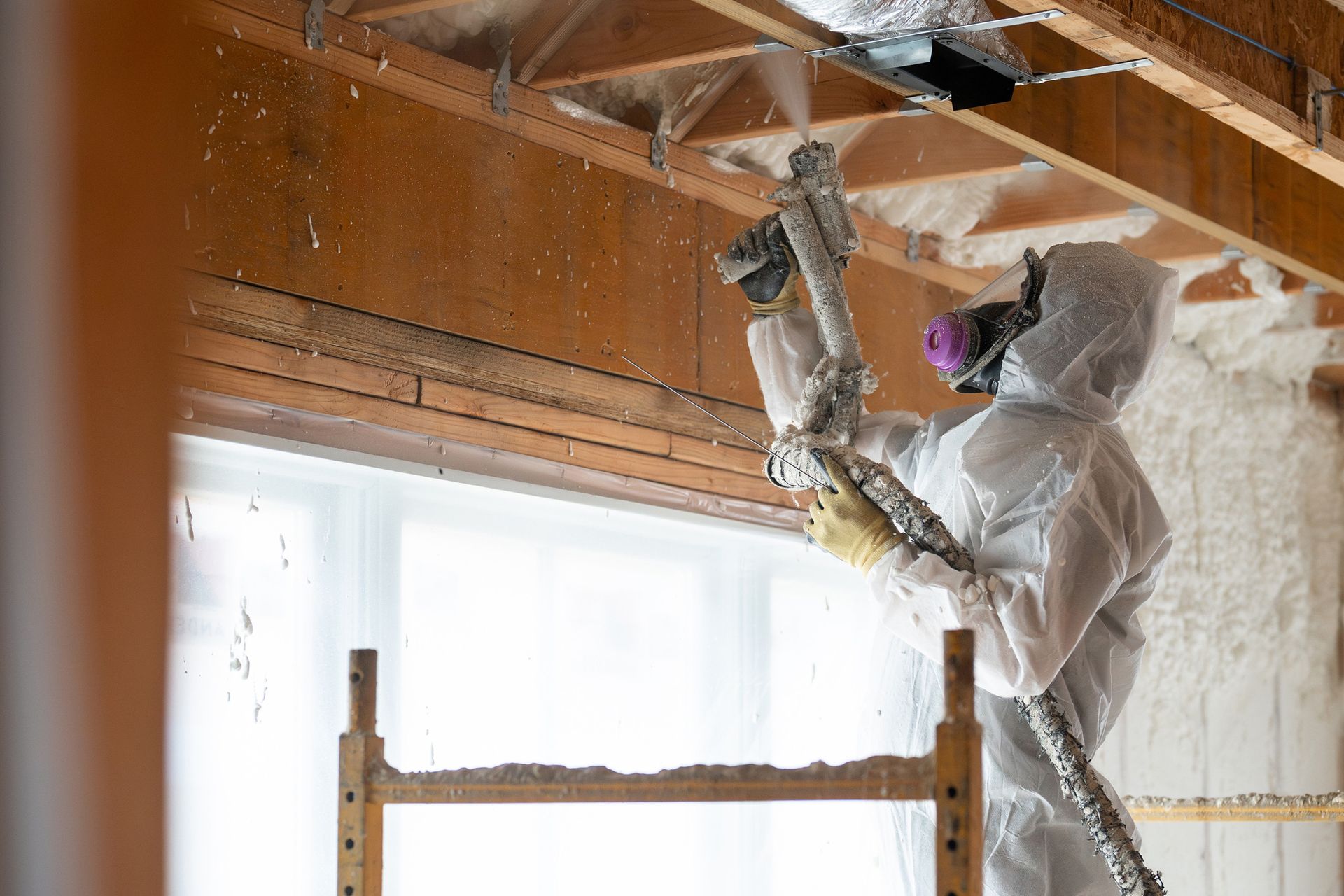 Technician installing insulation in a residential home.