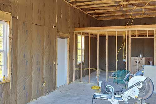 A circular saw is sitting in the middle of a room under construction.