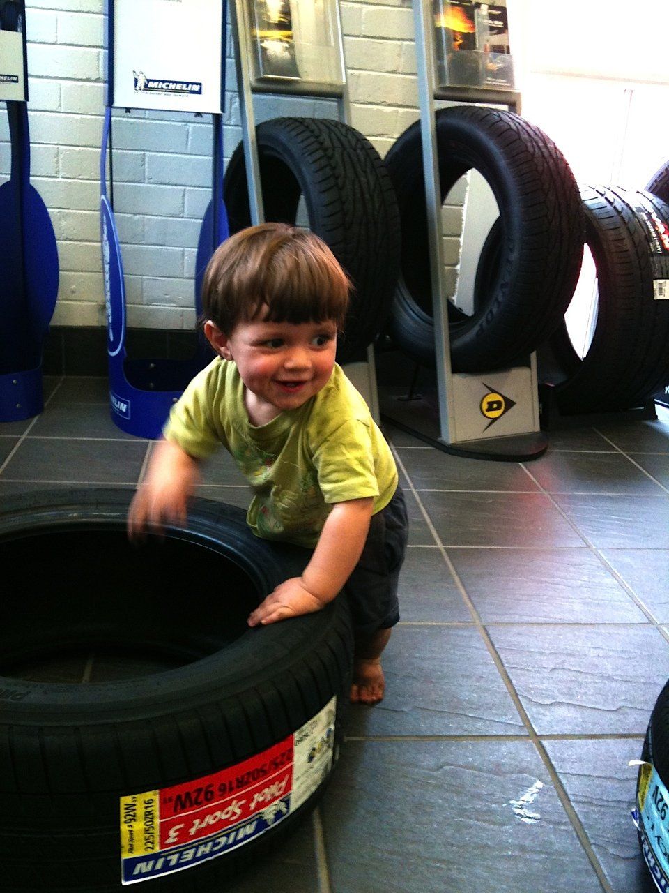 baby playing with tyres