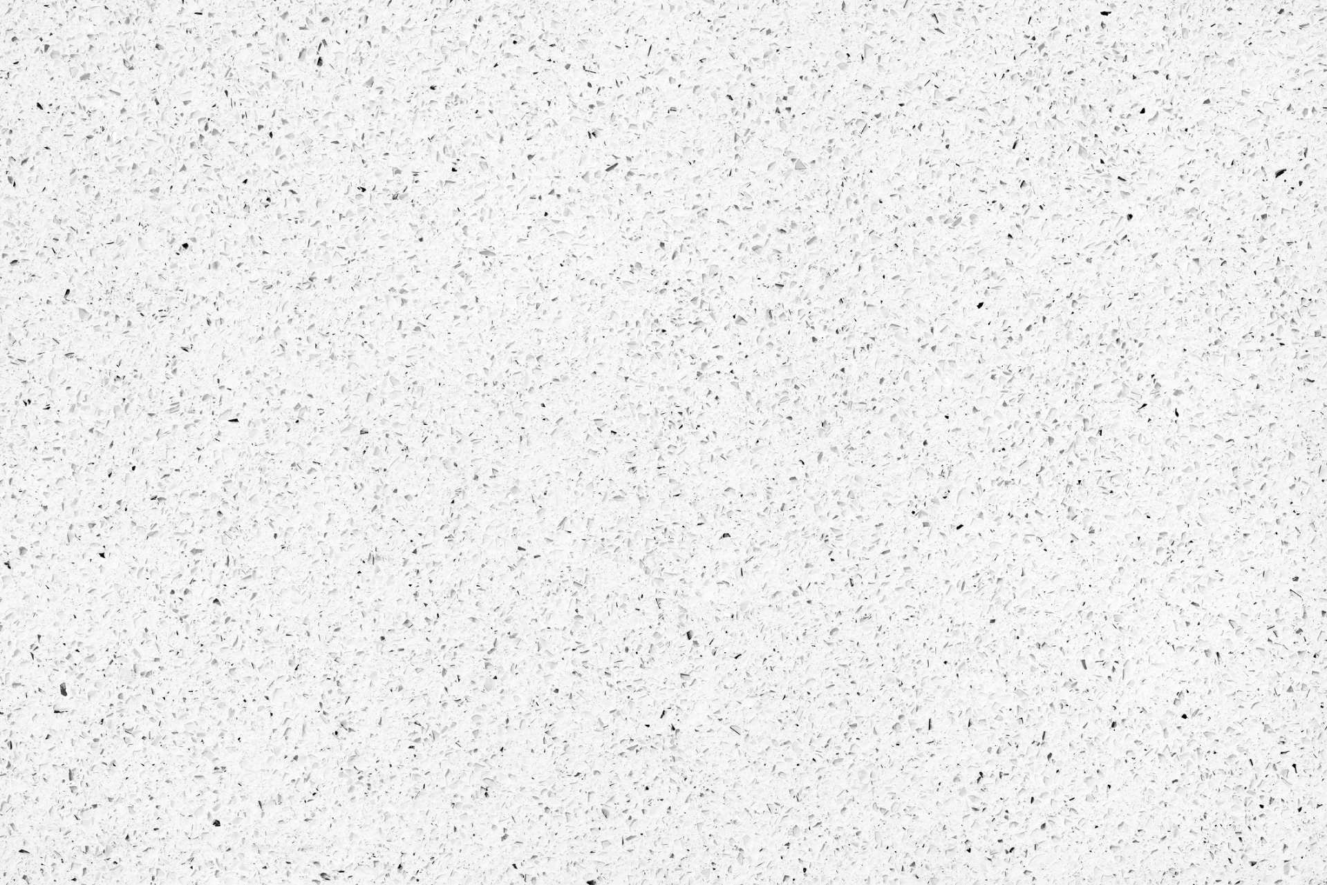 Un primo piano di una superficie bianca con puntini neri.