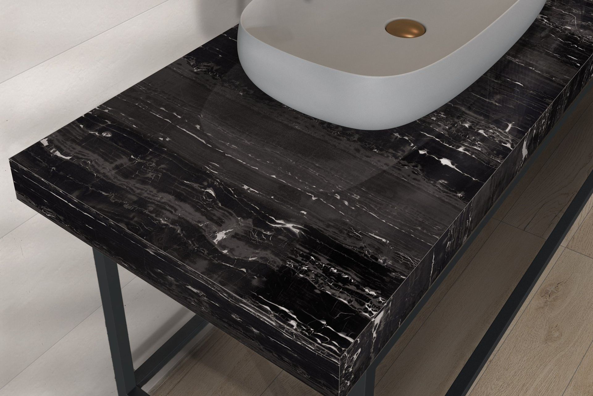 Un piano di lavoro nero con un lavandino bianco sopra