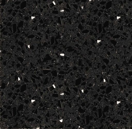 Primo piano di un piano di lavoro in granito nero con macchie bianche.