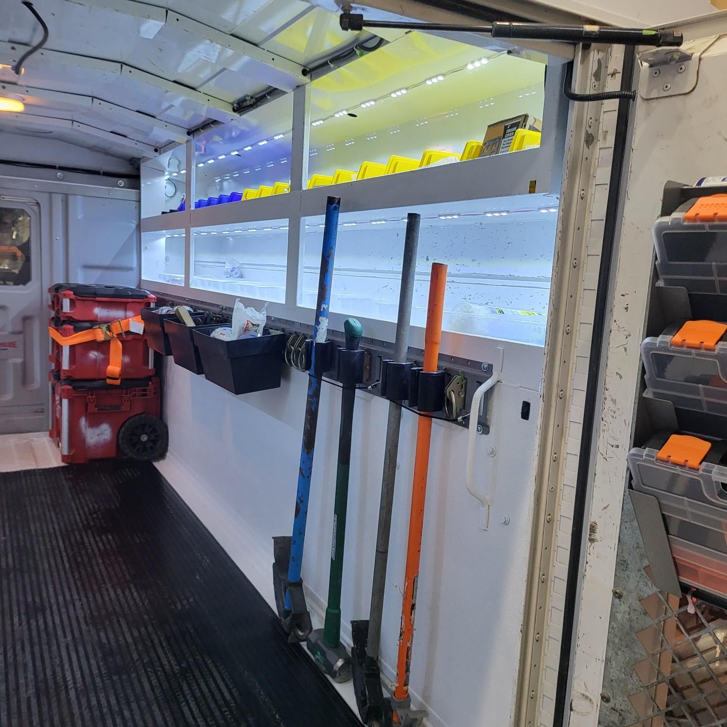 A bunch of tools are hanging on a wall in a truck