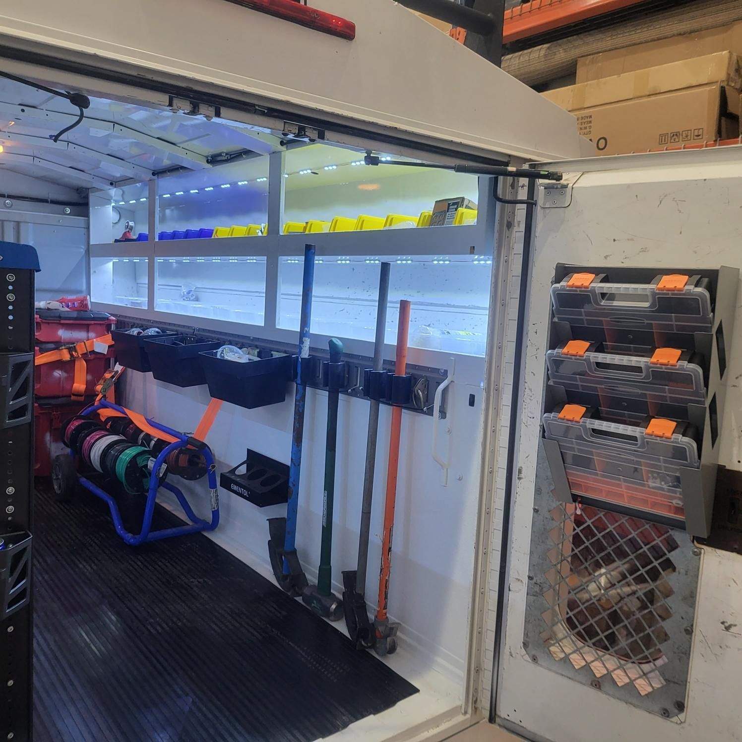 The inside of a van with tools hanging on the wall