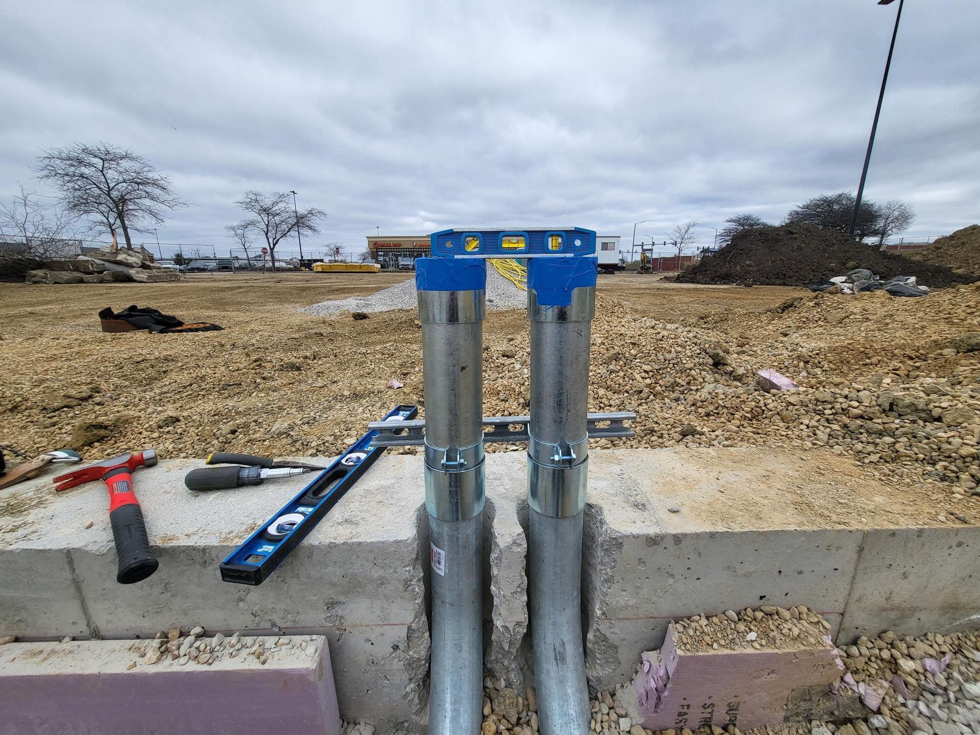A couple of metal pipes sitting on top of a concrete block.