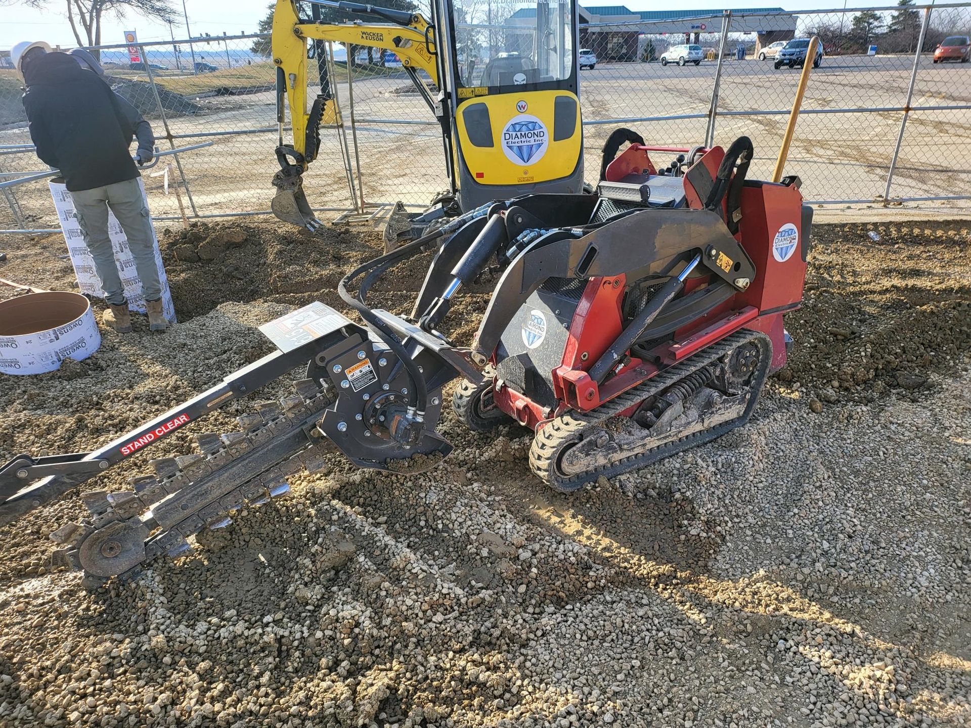 A yellow excavator is digging a hole in the dirt.