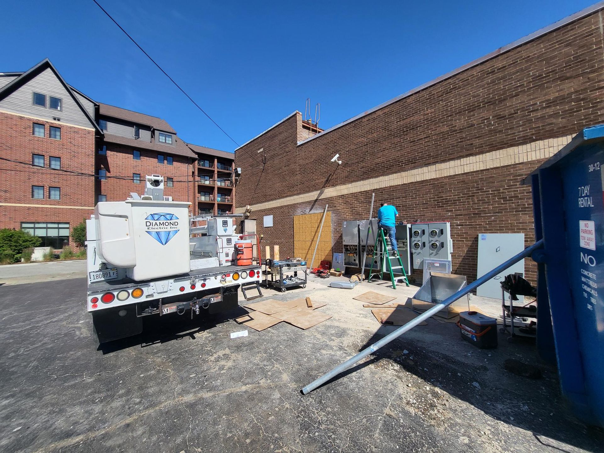 A white truck is parked in front of a brick building.