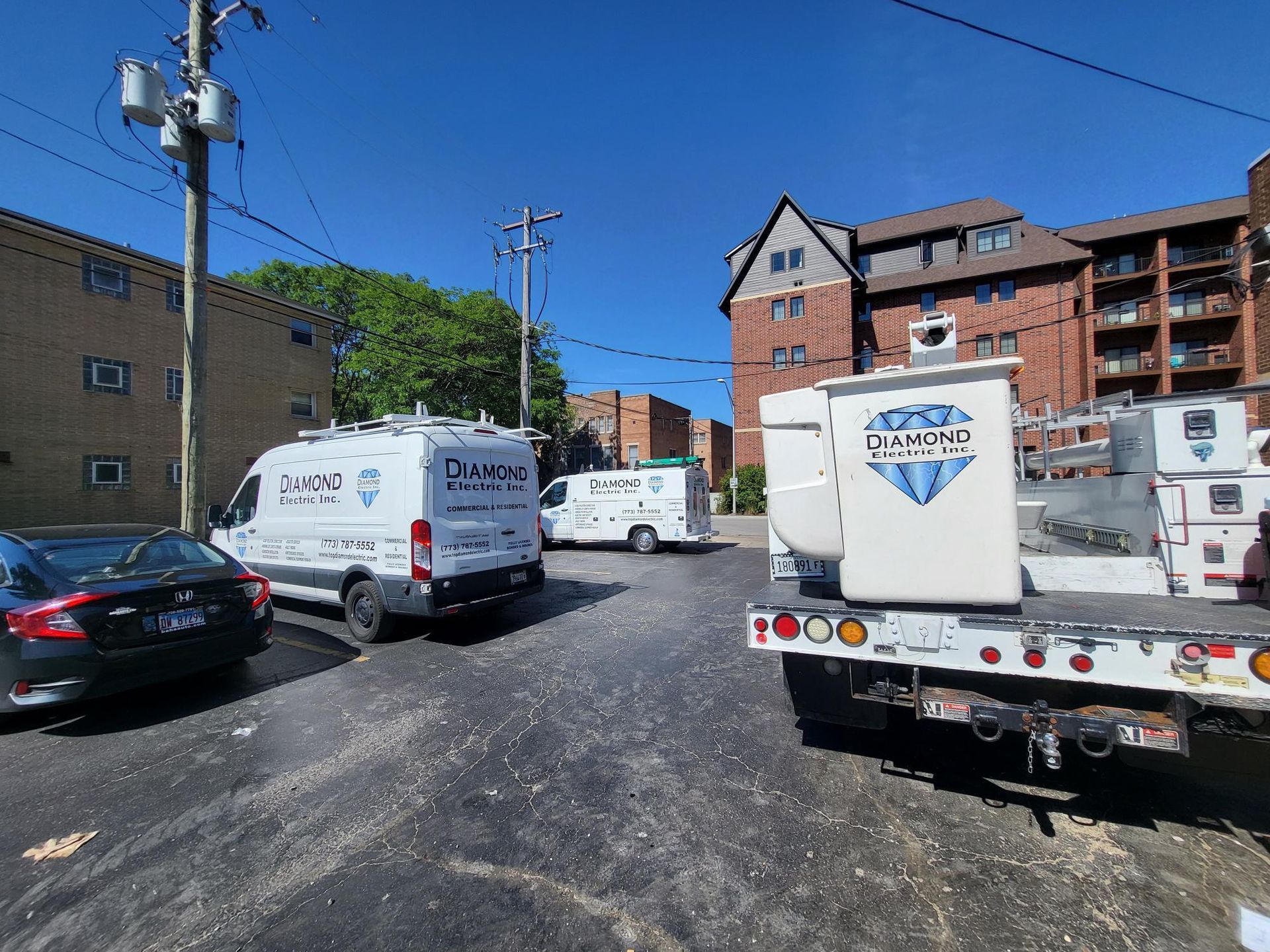 A truck with a bucket on the back of it is parked in a parking lot.