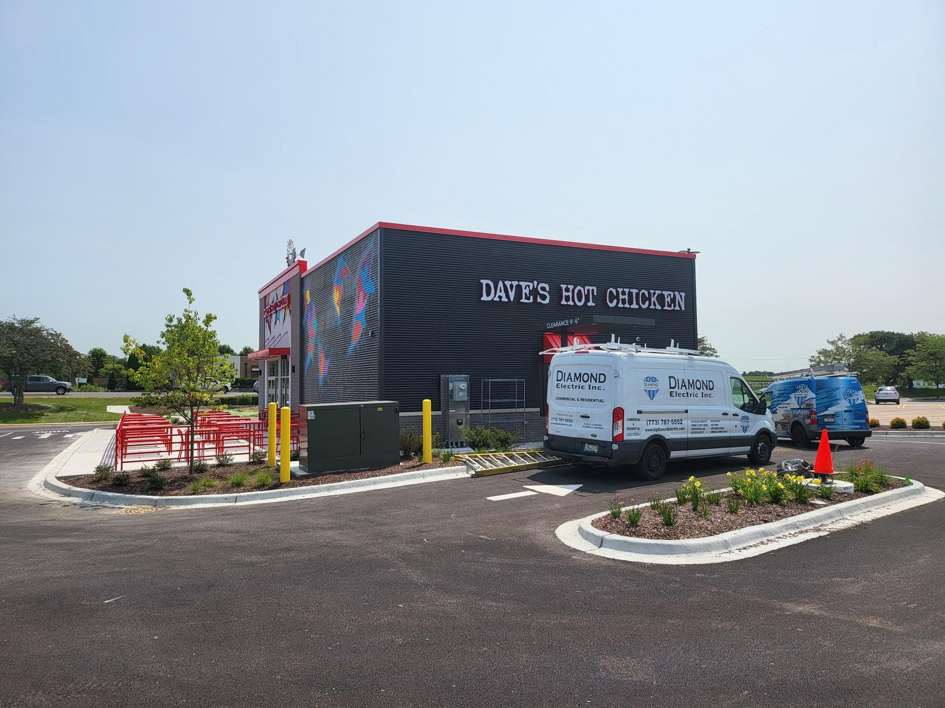 A white van is parked in front of a building that says dave 's ice cream