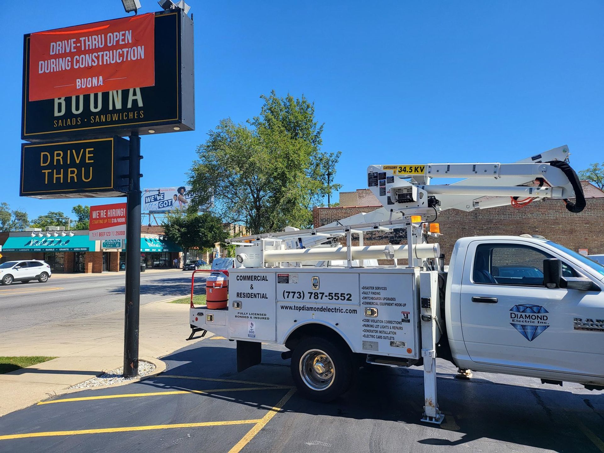 A white truck is parked in front of a sign that says drive thru