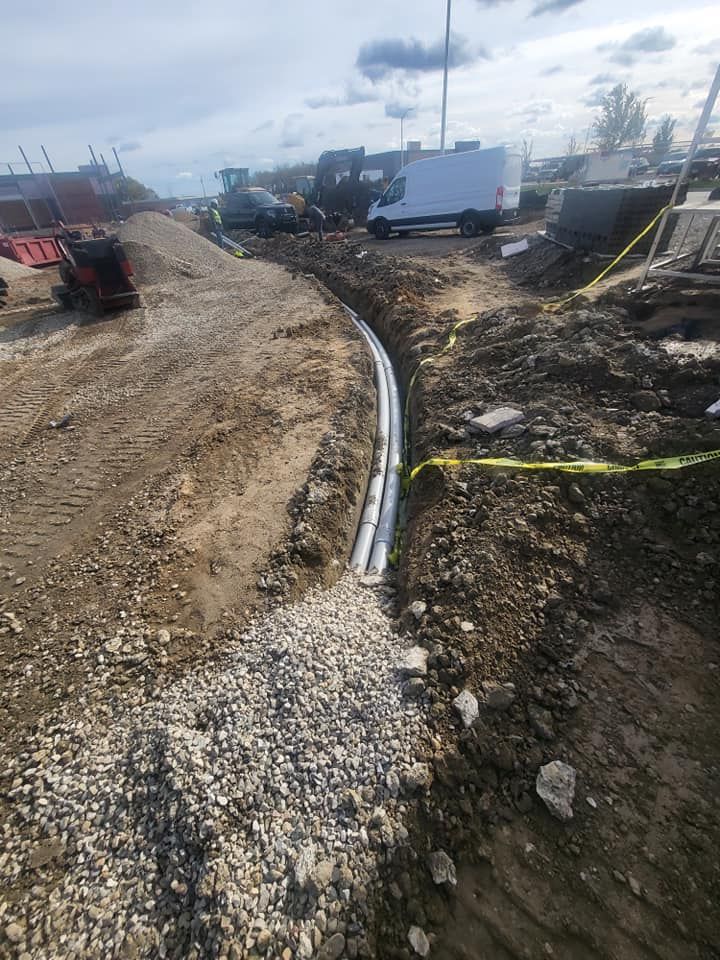 A pipe is being installed in the dirt in a construction site.