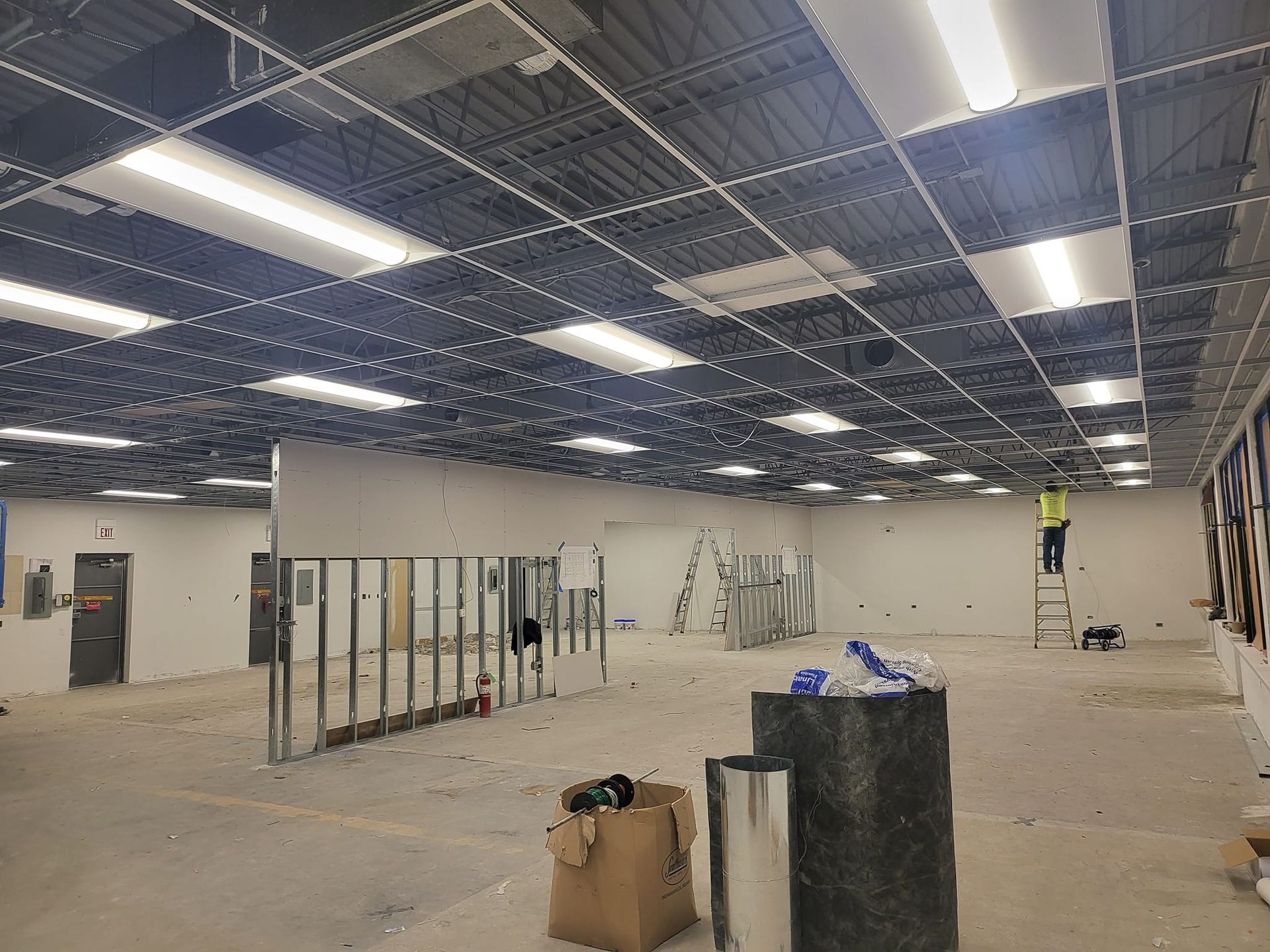 A large empty room with a ceiling that is being remodeled.