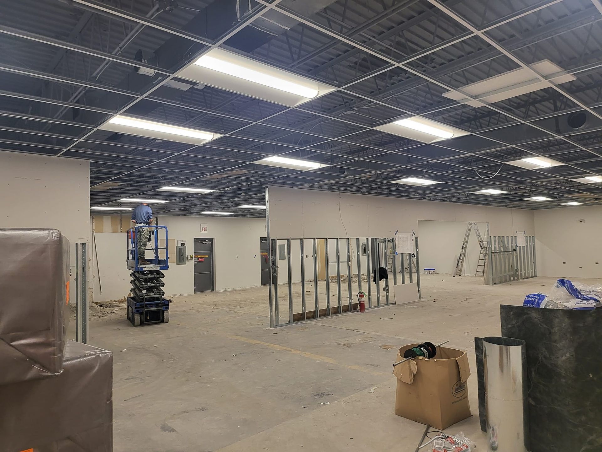 A large empty room with a ceiling that is being remodeled.