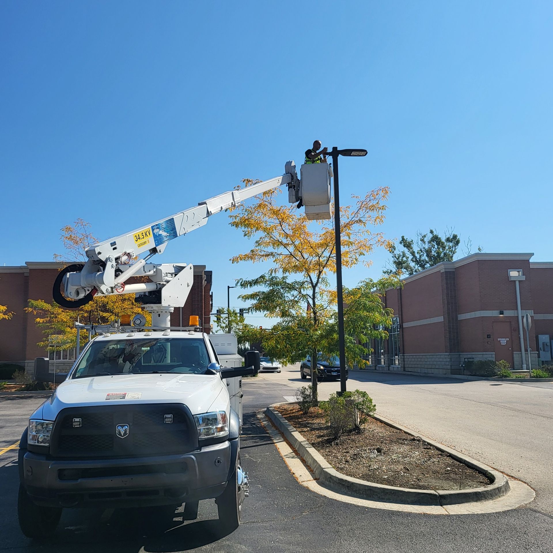 A white truck with a crane on top of it