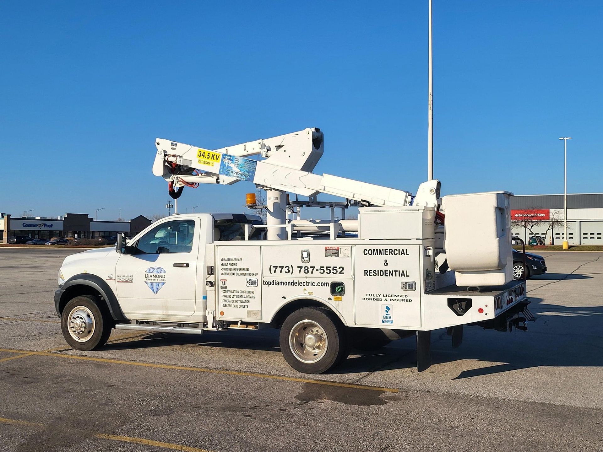 A white utility truck is parked in a parking lot