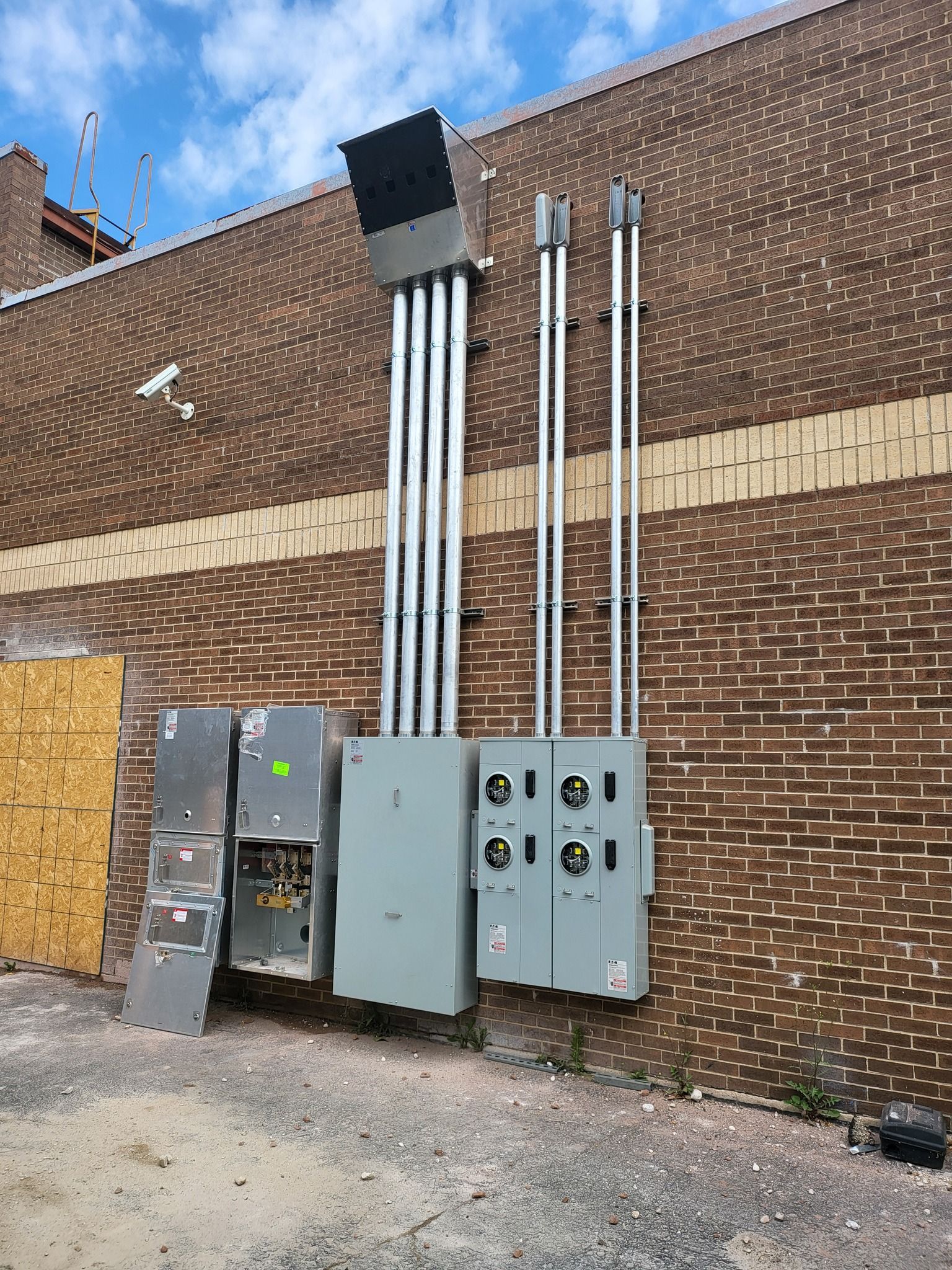 A brick building with electrical boxes on the side of it.