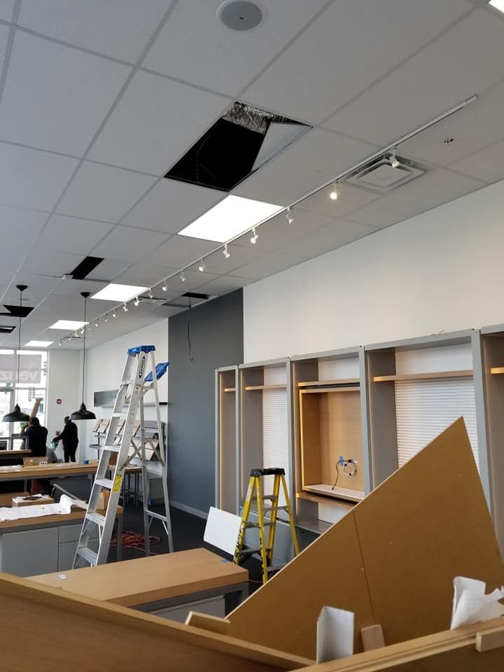 A room with a ladder in it and a hole in the ceiling