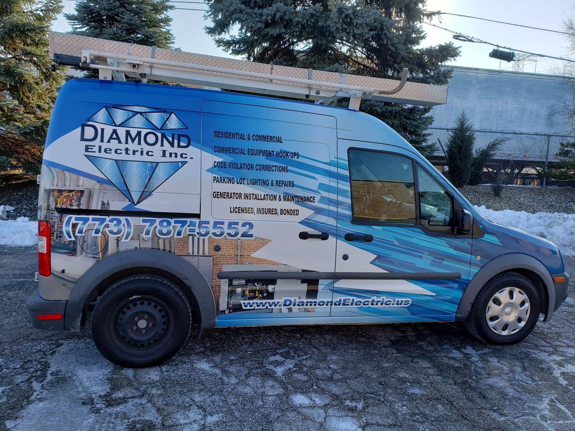 A diamond electric inc. van is parked in the snow.