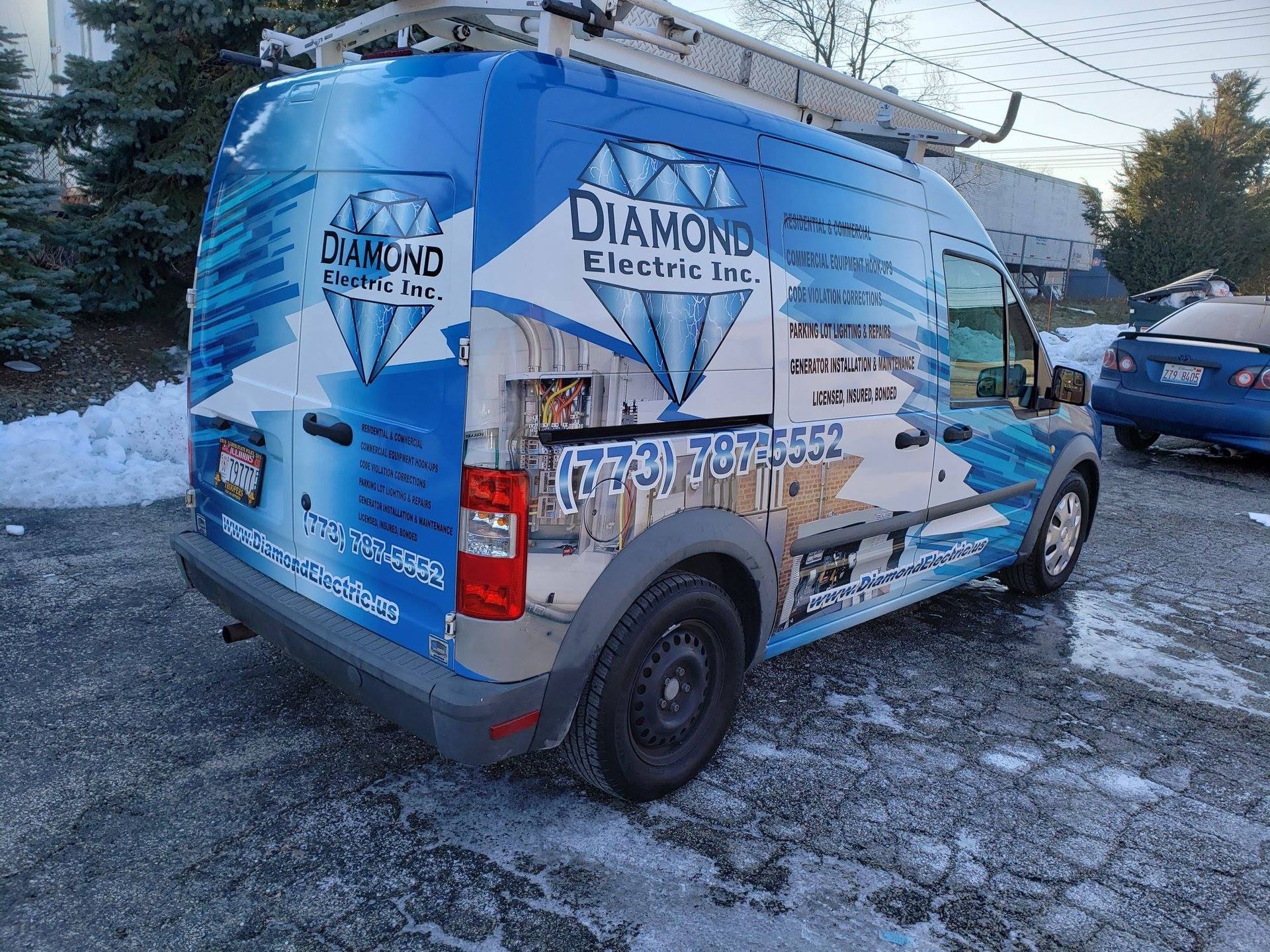 A diamond electric inc. van is parked in the snow.