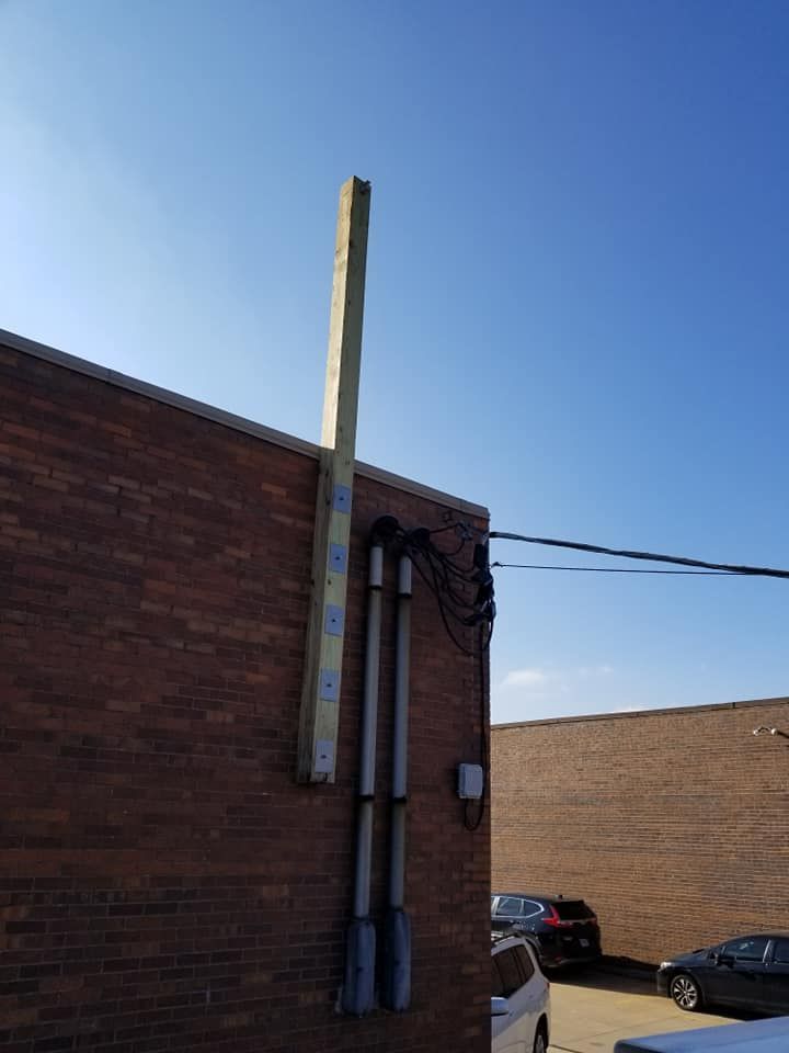 A brick building with a sign on the side of it