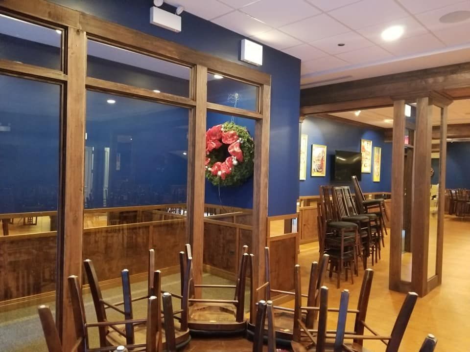 An empty restaurant with a wreath on the wall