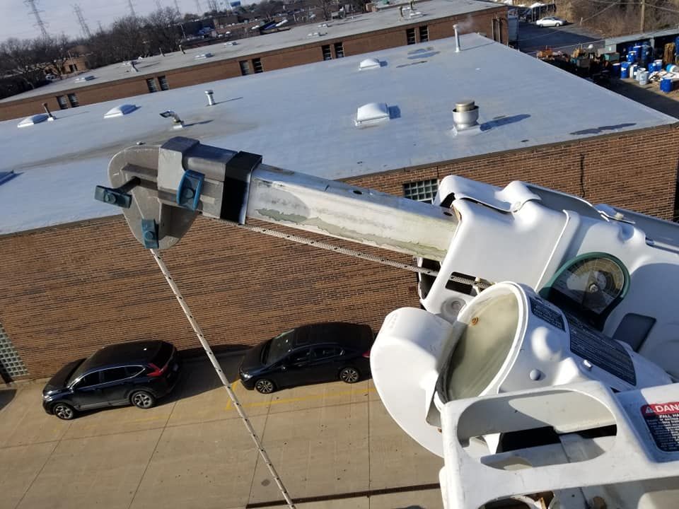 An aerial view of a crane in front of a building