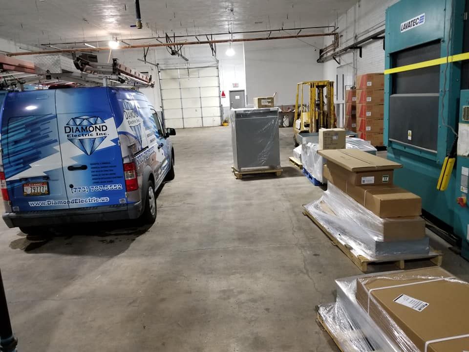 A blue van with the word diamond on the back is parked in a garage