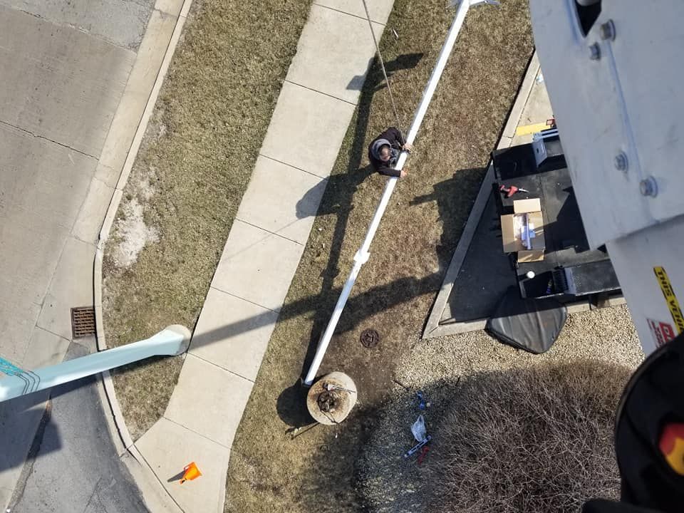 An aerial view of a person standing on a sidewalk next to a truck
