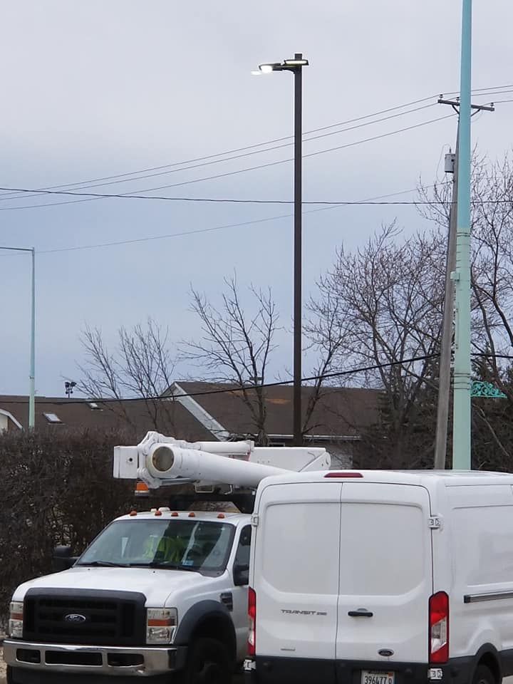 A ford truck is parked next to a white van