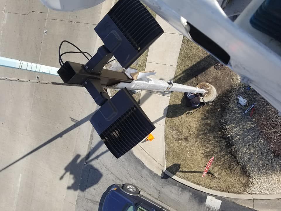 An aerial view of a street light and a car