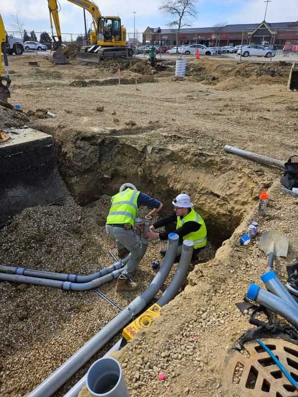 A couple of men are working on a construction site.