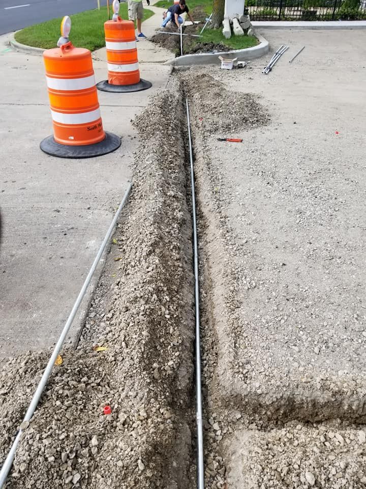 A row of orange and white traffic cones on the side of a road