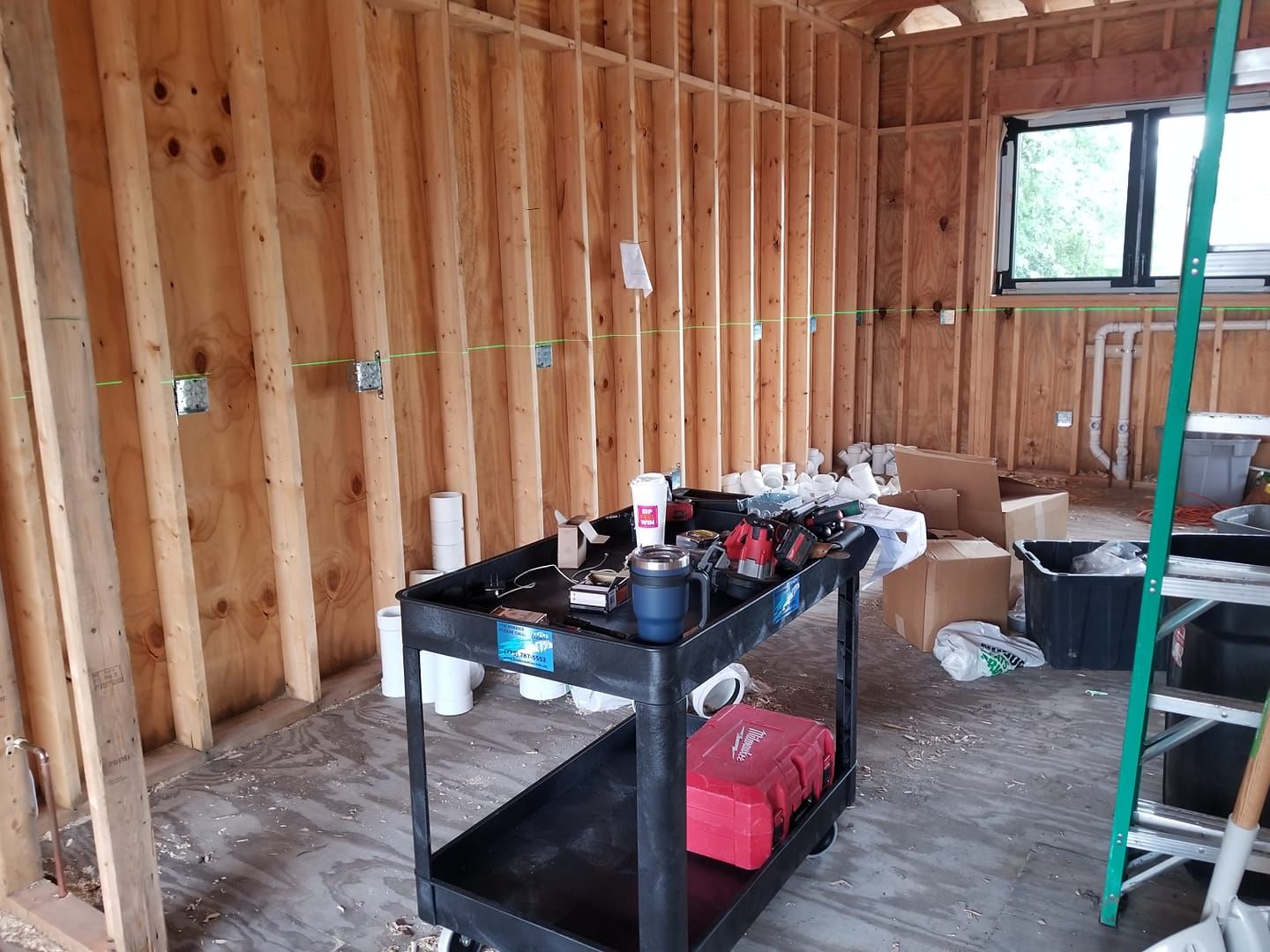 There is a cart with tools on it in the middle of the room.