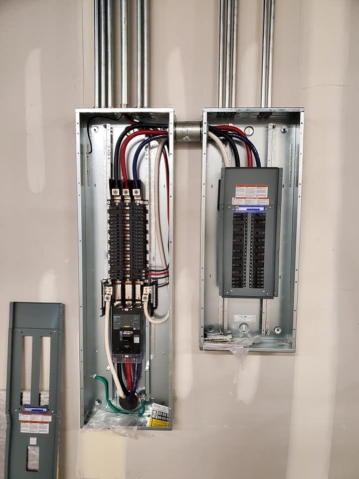 A couple of electrical boxes hanging on a wall.