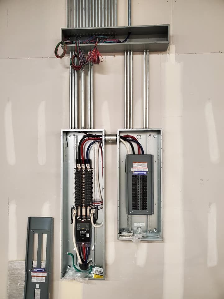 A couple of electrical boxes hanging on a wall.