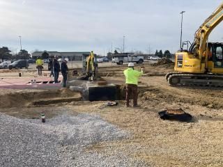 A group of construction workers are working on a construction site.