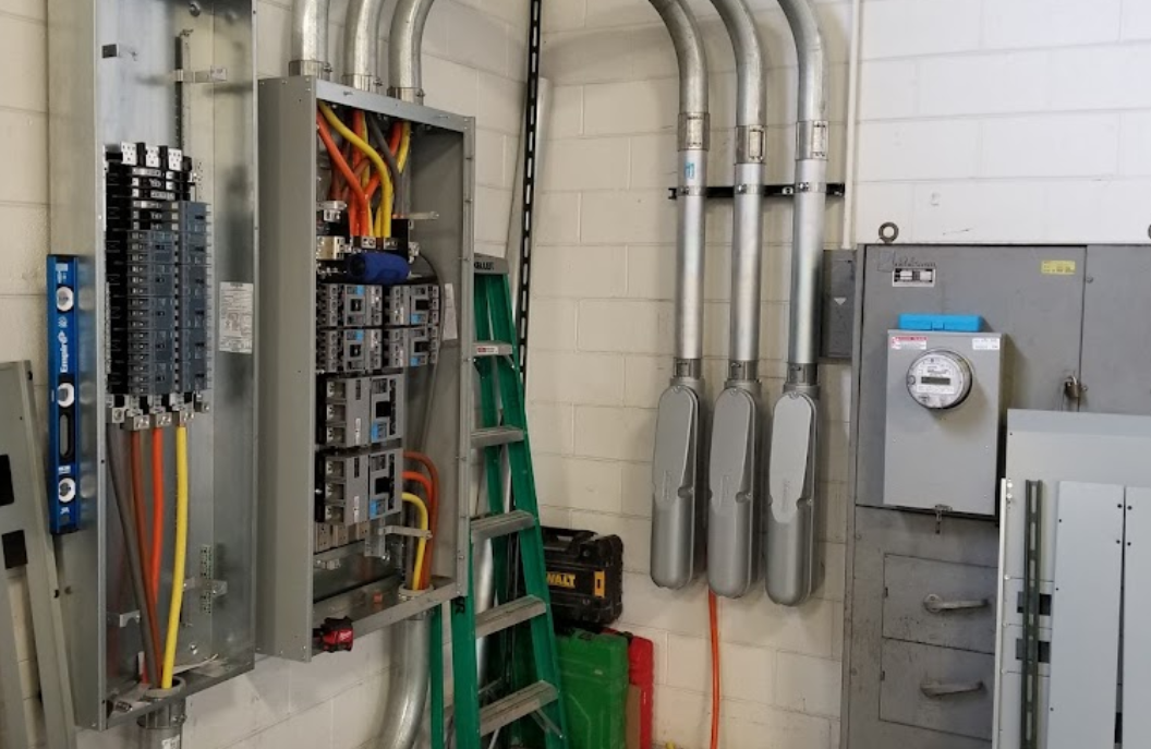 A room filled with electrical equipment and a ladder.