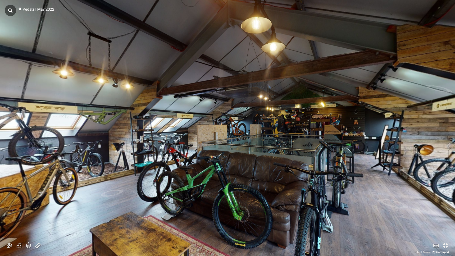 A room filled with lots of bicycles and a couch.